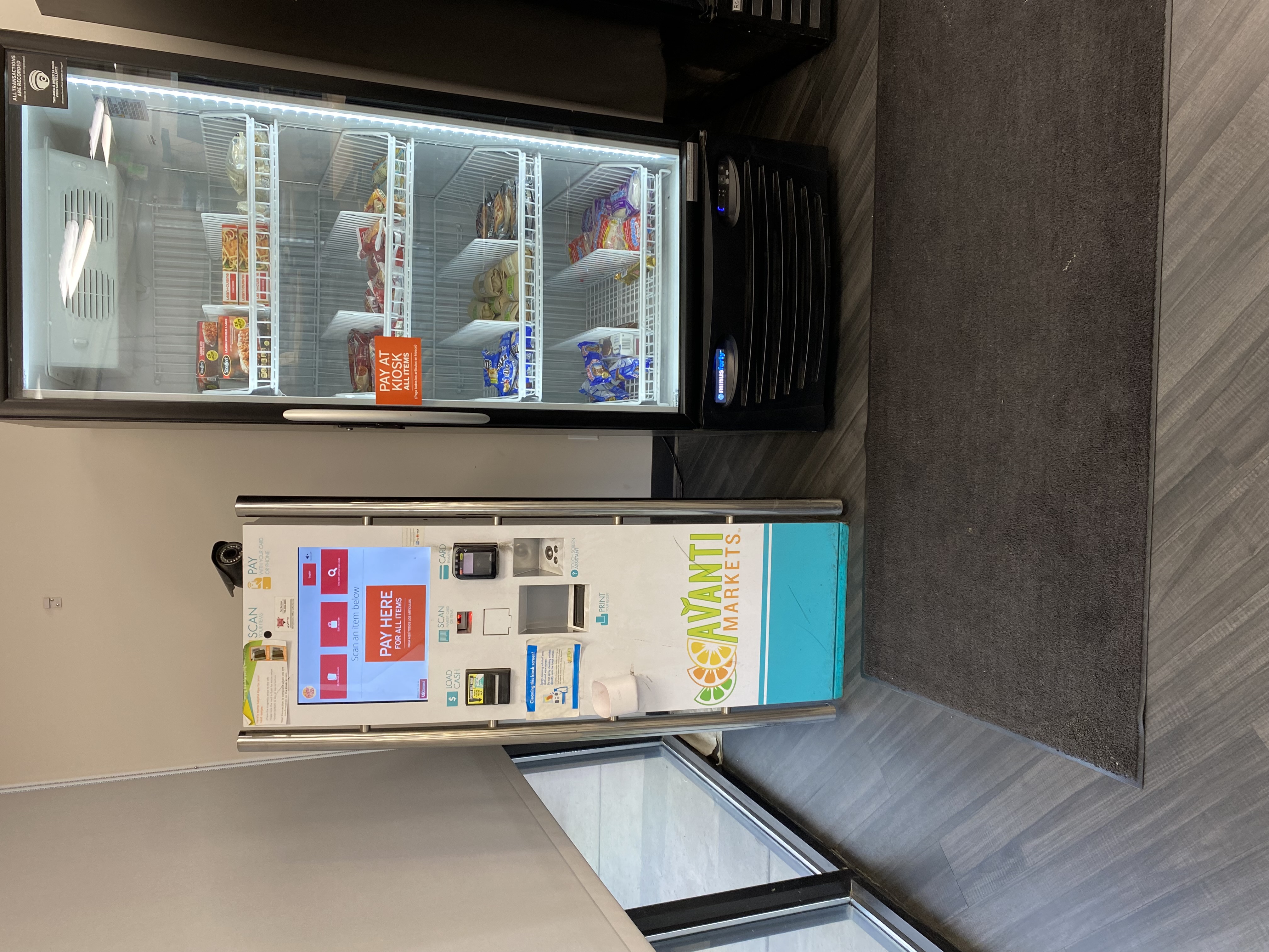 Transparent background self-checkout kiosk in micro-market